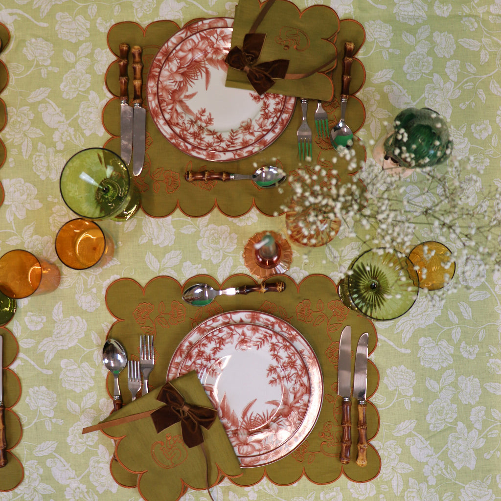 Earthen Pine Napkin in a warm dinner party setting with candles and flowers - Ro'Table NYC