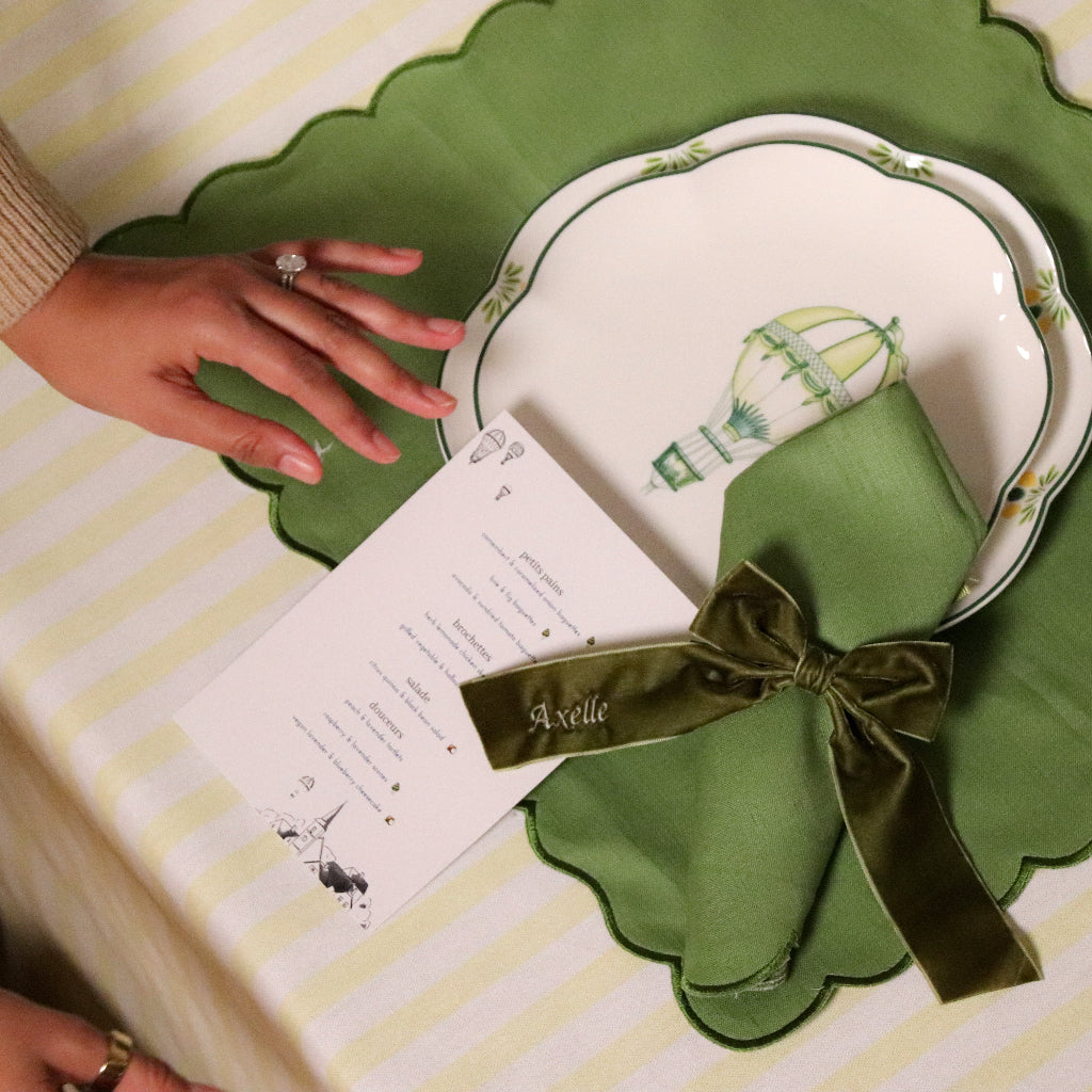 Large Forest Green Velvet Napkin Bow Tie in a warm dinner party setting - Ro'Table NYC