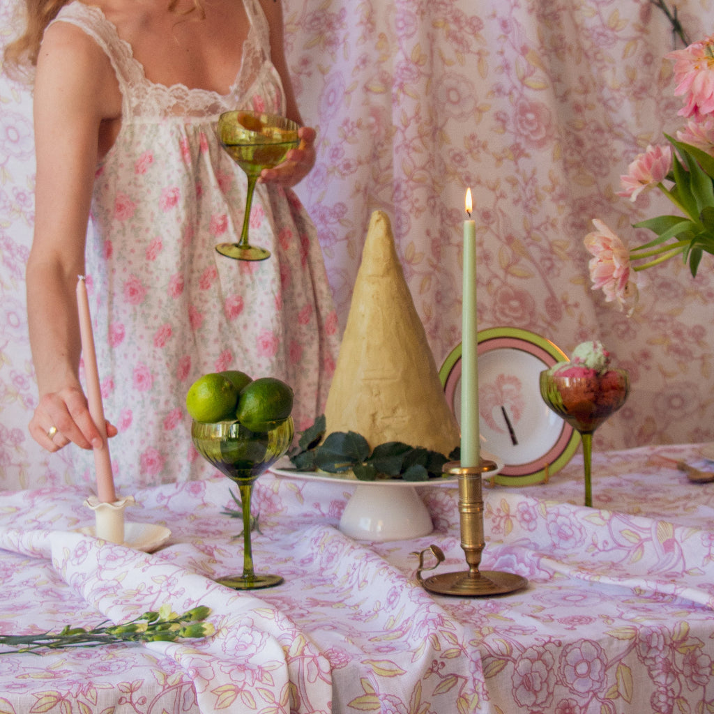 Extra Tall Pistachio Cream Taper Candle in a warm dinner party setting with candles and flowers - Ro'Table NYC