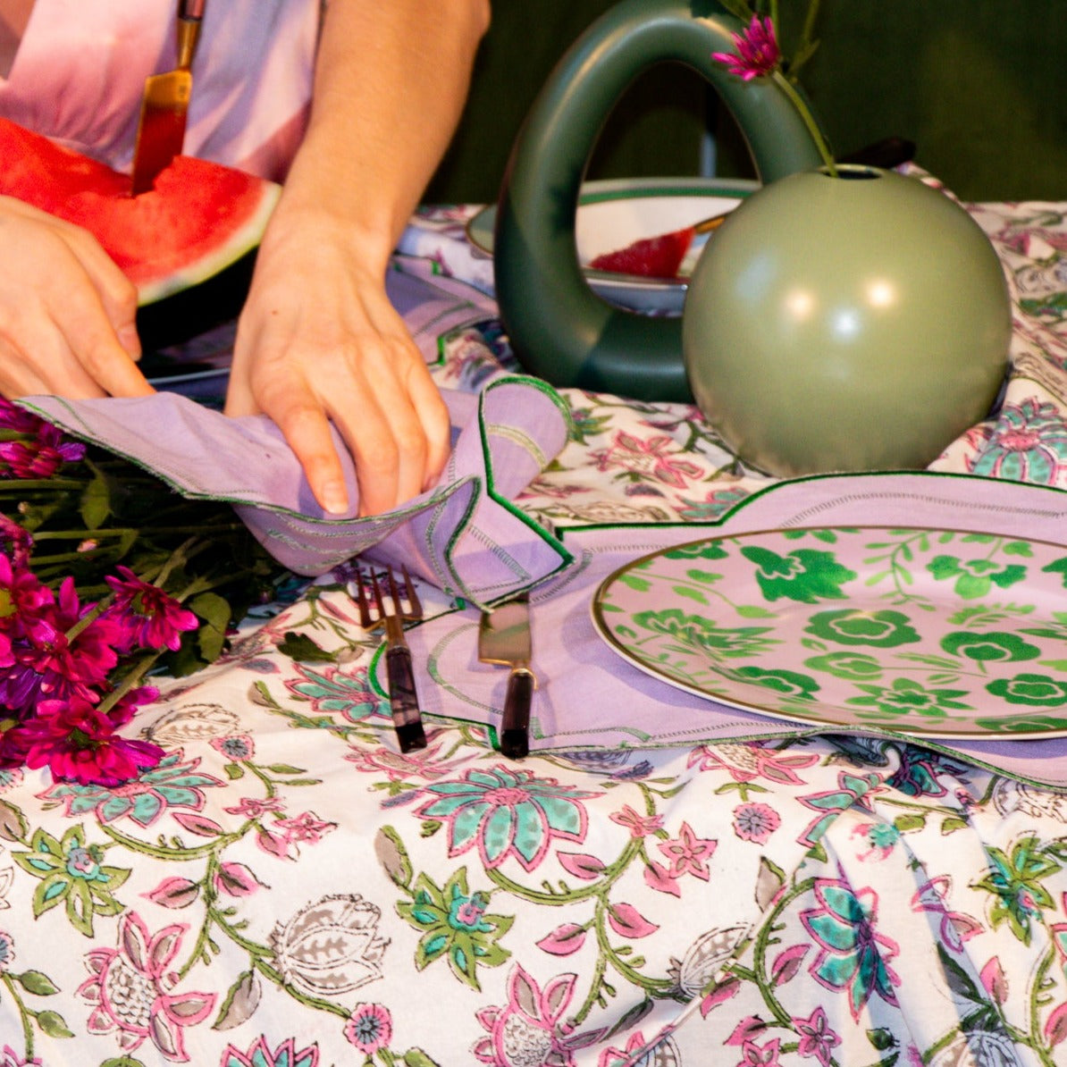 Tablescape of lilacs and Greens, Palm Springs. A tablecloth that is reminiscent of a thriving garden