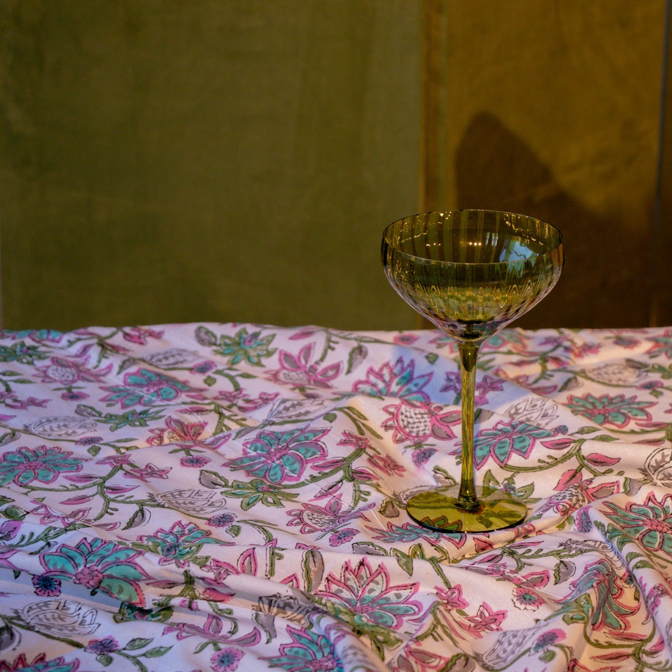 Tablescape of lilacs and Greens, with a Champagne Coupe Standing on its own