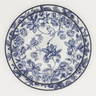 Blue starter plate atop a blue dinner plate floral monkey