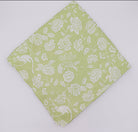 Pistachio Green tablecloth made from the finest quality linen, featuring a delicate white design of subtle monkeys and floral patterns