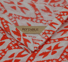 A Cotton Tablecloth by Ro'Table NYC in Tangerine-coral. Hue and print, reminiscent of radiant sunsets and vibrant coral reefs