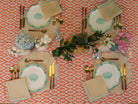 A coastal table setting - A Cotton Tablecloth in Tangerine-coral. Hue and print, reminiscent of radiant sunsets and vibrant coral reefs