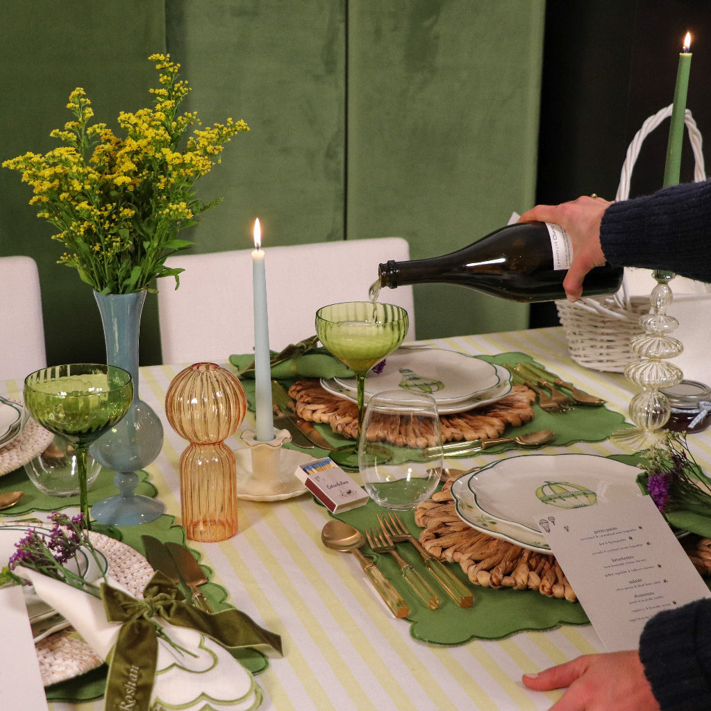 Sage Ribbed Coupe - Pair - One green ribbed coupe being poured with champagne while standing on an elegant green and yellow luxury table setting - Ro'Table NYC