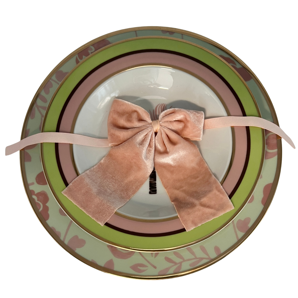 Decorative plate with a pink bow and floral patterns on a white background - Ro'Table NYC